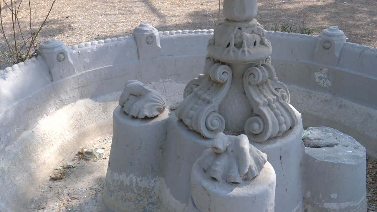 Closeup shot of a base of white marble fountain during daytime at Goolbai Maternity Home in Karachi, Pakistan