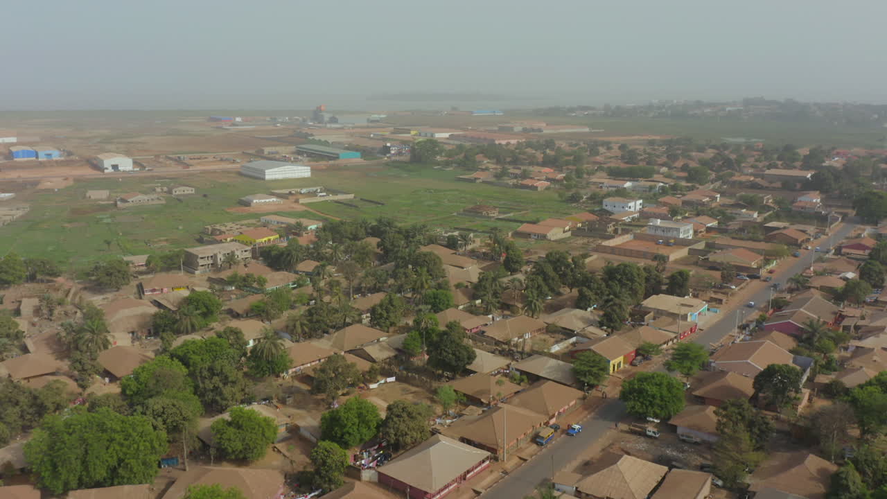 The widespread urban development and daily life in Bissau, the capital of Guinea-Bissau, West Africa. Features busy streets, tightly packed homes, and unique architecture