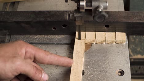 close shot of a machine that is cutting wood in a square shapes