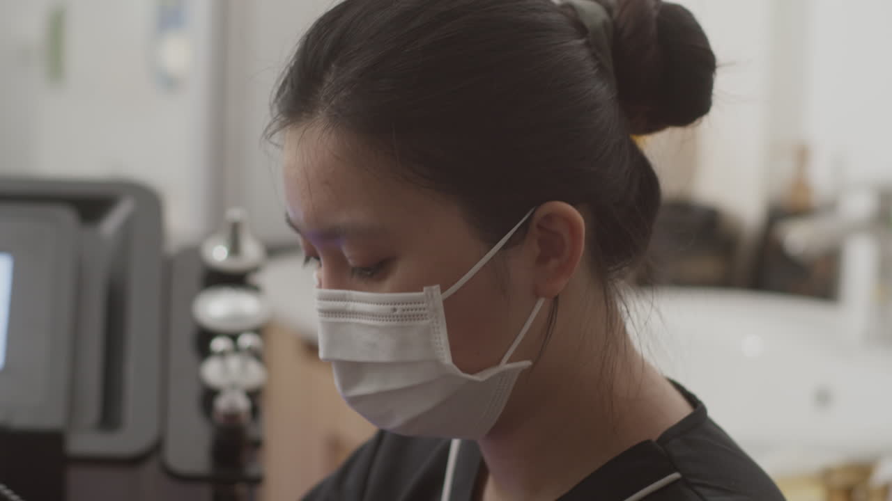 Beautician Giving Photodynamic Therapy to Female Client