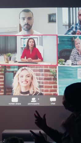 vertical video multiethnic group attends a digital meeting from the office at night