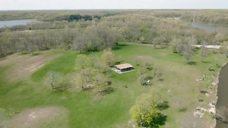 Aerial-circular-motion-around-a-pavilion-in-a-public-park-near-a-lake