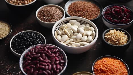 various superfoods in smal bowls on dark rusty background