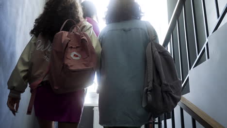 back view of girls going upstairs