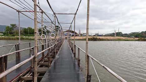 walking across a scenic bridge in thailand