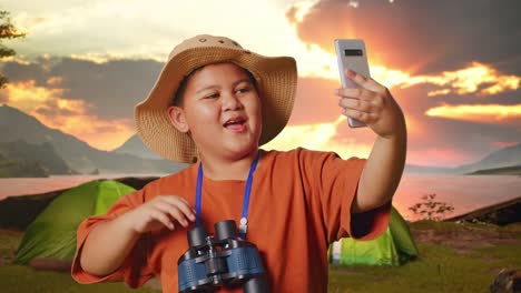 happy kid taking selfie while camping
