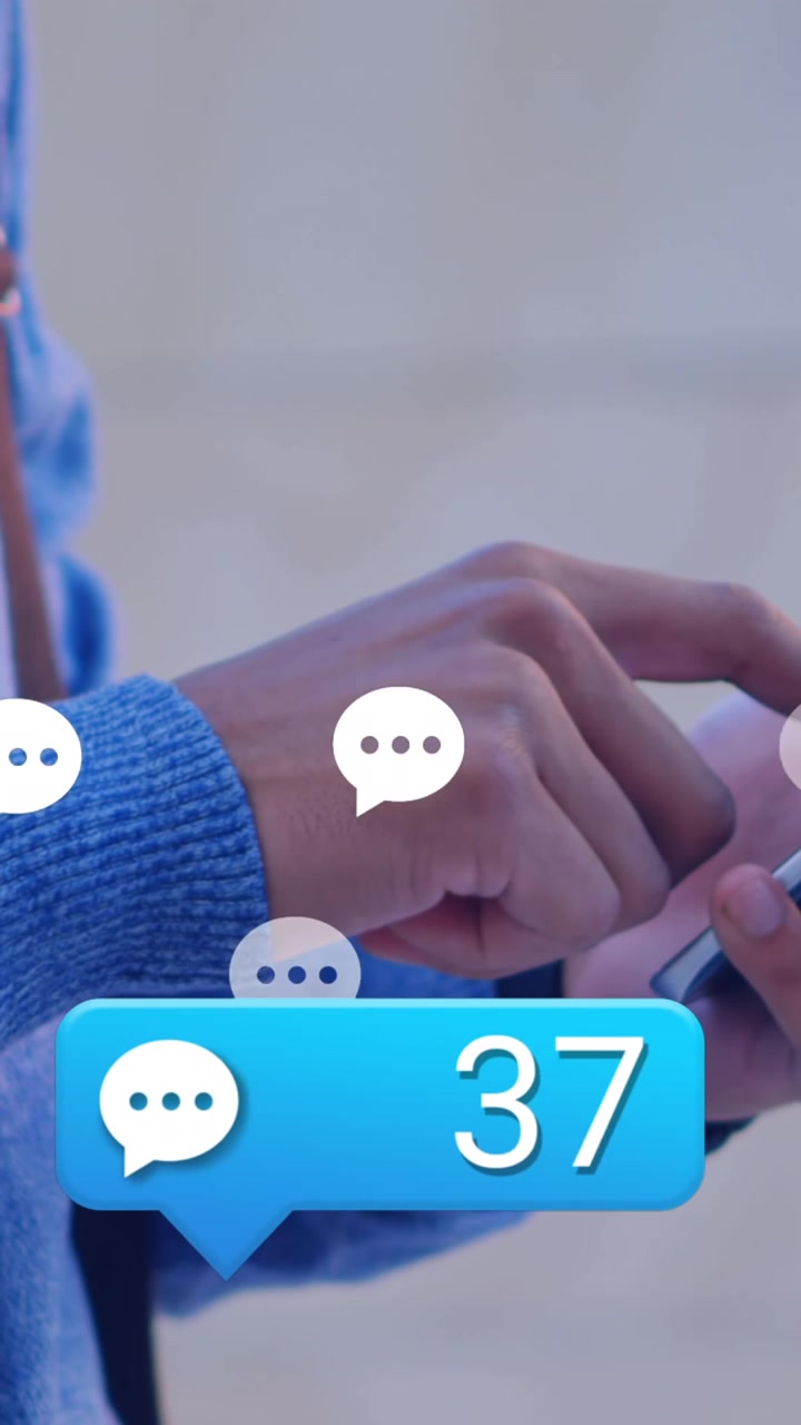 Animation of social media reaction over hands of caucasian man using smartphone