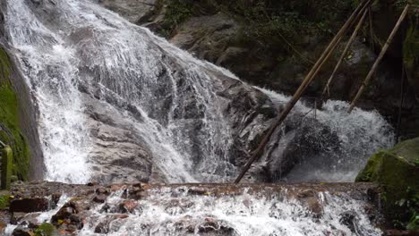 stunning waterfall cascades in jugnle, medium locked off shot