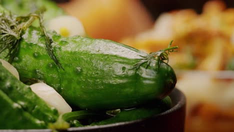 close-up of fermented cucumbers with garlic and dill on plate. preservation of vegetables in glass jars. fermentation preserved cucumbers with spices. russian cuisine.