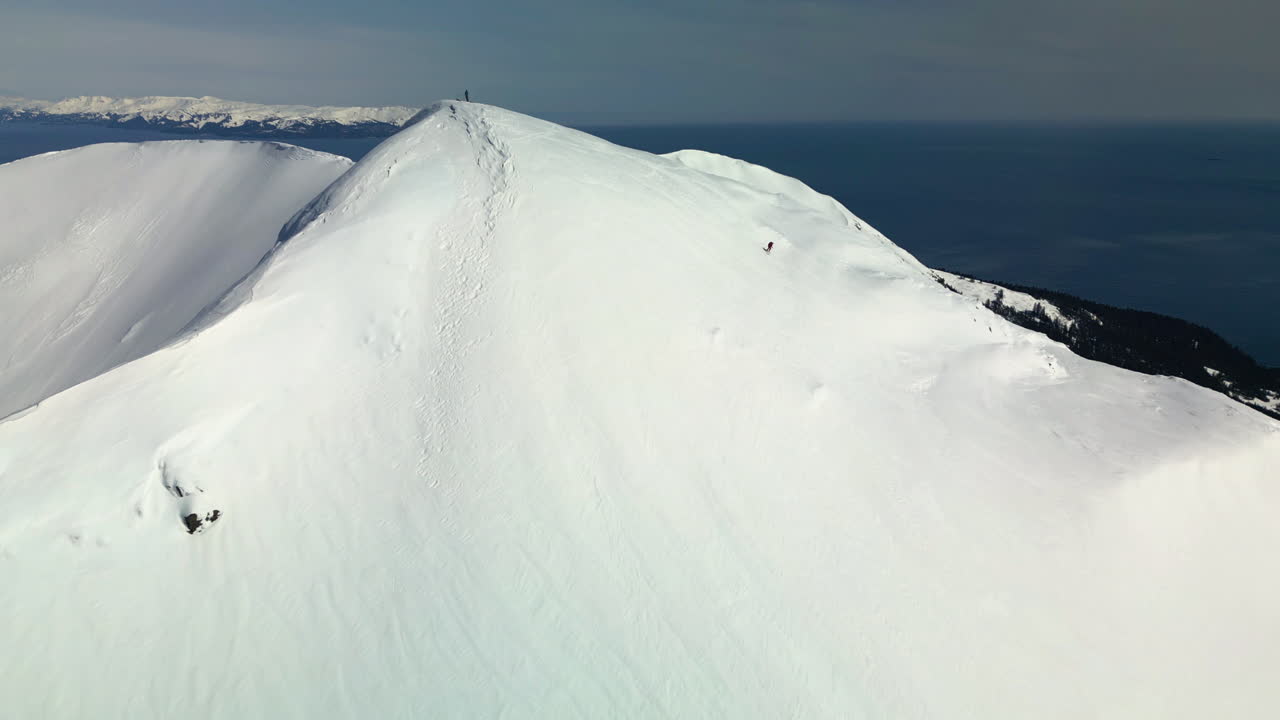 vista aérea de un freerider de montaña salvaje esquiando por las empinadas laderas de alaska