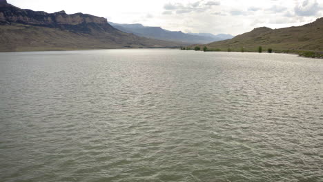 tranquil lake with rippling water and distant mountains
