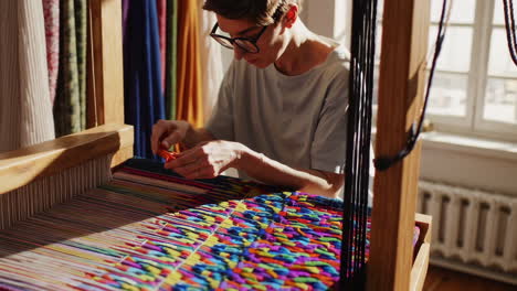 woman weaving on a loom