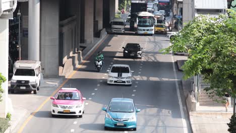 vehicles and motorcycles on a busy bangkok street