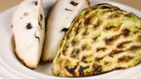 sliced custard apple displayed on a plate