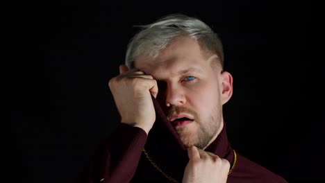 stylish man with blue eyes in trendy clothes looking at camera, feeling happiness, fun, enjoyment