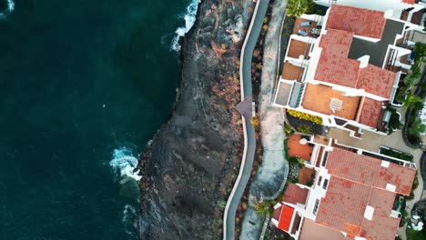 the drone captures crashing waves on los gigantes town shoreline