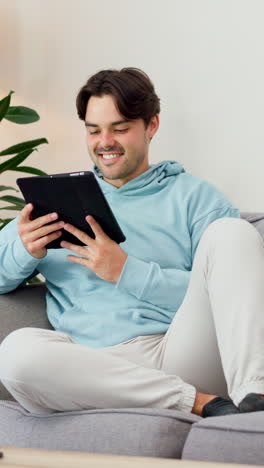 Happy,-man-and-relax-with-tablet-on-sofa-to-watch