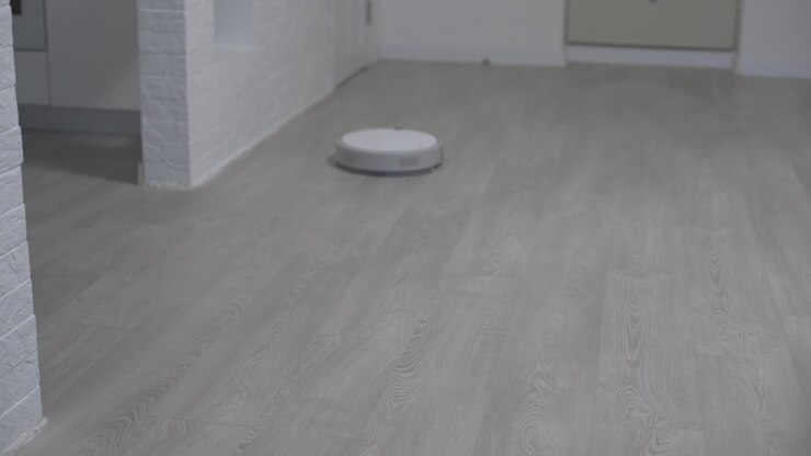 Robot vacuum cleaner autumate, clean floor machine. Vacuum Robot auto cleaning at home. Robot vacuum cleaner performs automatic cleaning of the apartment. Smart home.
