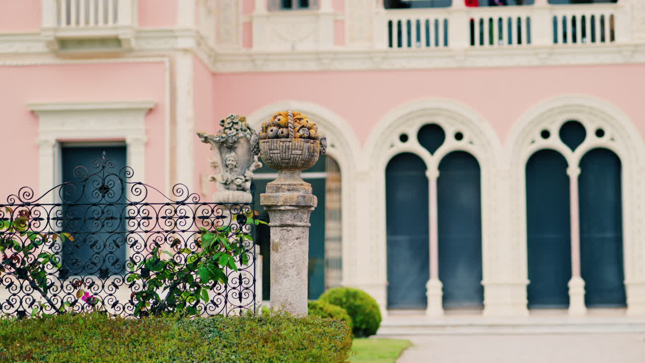 Close up of a decorative stone pillar in the courtyard of Villa Ephrussi de Rothschild with a blurred view on the background
