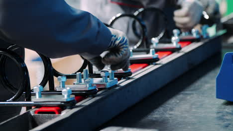 men carry out manual assembly of industrial equipment in factory shop