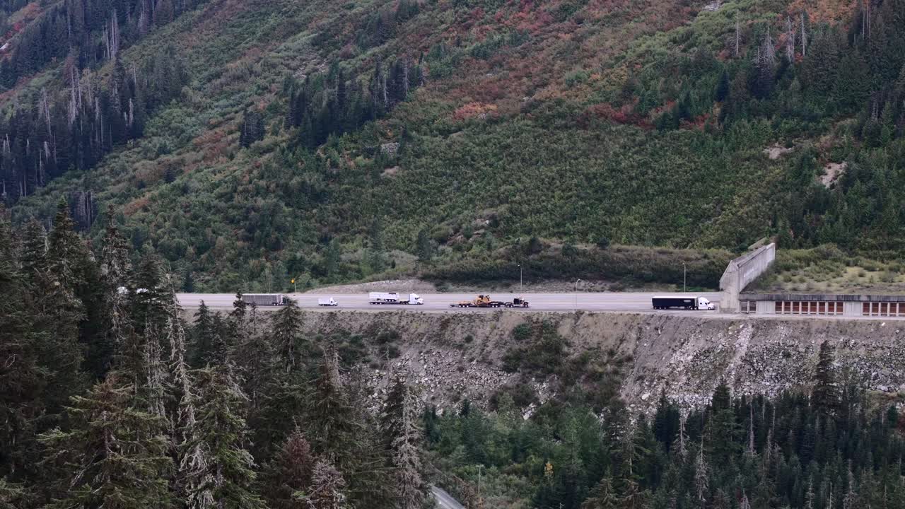 Semi Trucks Ascending Coquihalla's Challenging Slopes Toward Great Bear Snow Shed