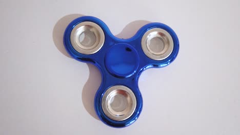 toy to relax known with spinner in blue color with white background.