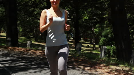 Woman-jogging-on-the-road-as-the-camera-follows-her