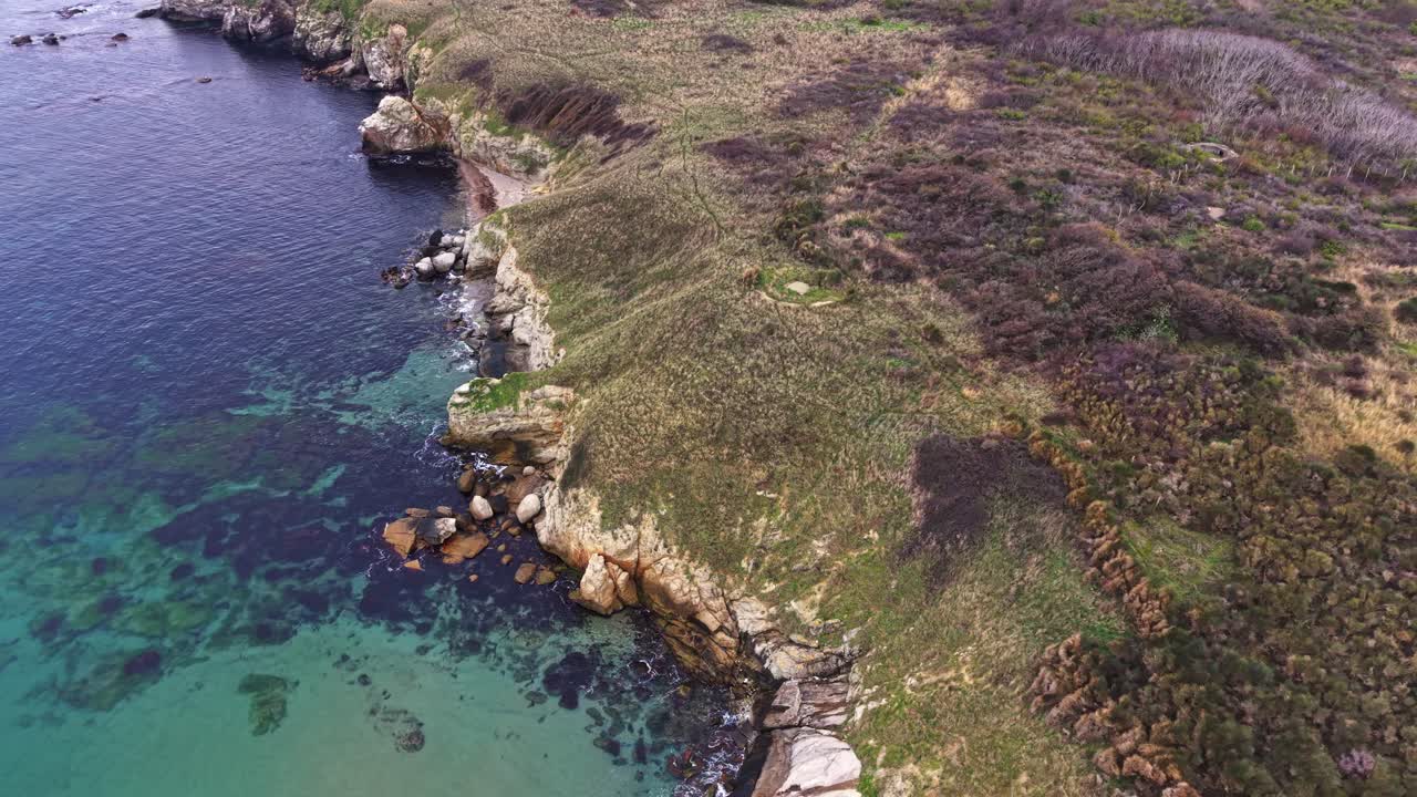 Coastal landscape featuring rocky shoreline and clear waters