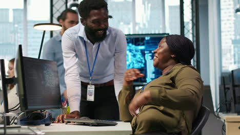cheerful programmers in office enjoying conversation while automating with ai