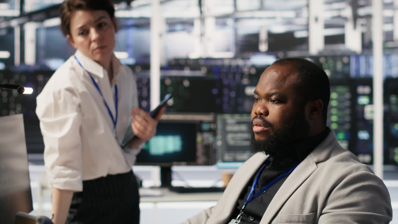 Vertical video Lead data center admin overseeing IT expert integrating AI in equipment rigs