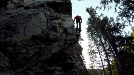 rock climber descending down from the cliff 4k