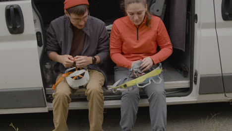 heterosexual couple sitting in a van