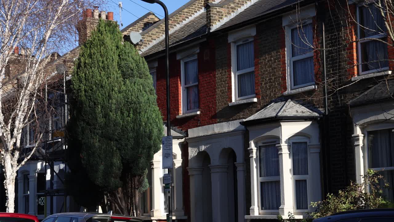Row house residential building with red brick facade and bay windows