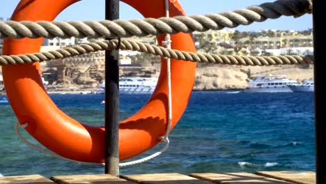 safety equipment, life buoy or rescue buoy on the wooden pier at the beach