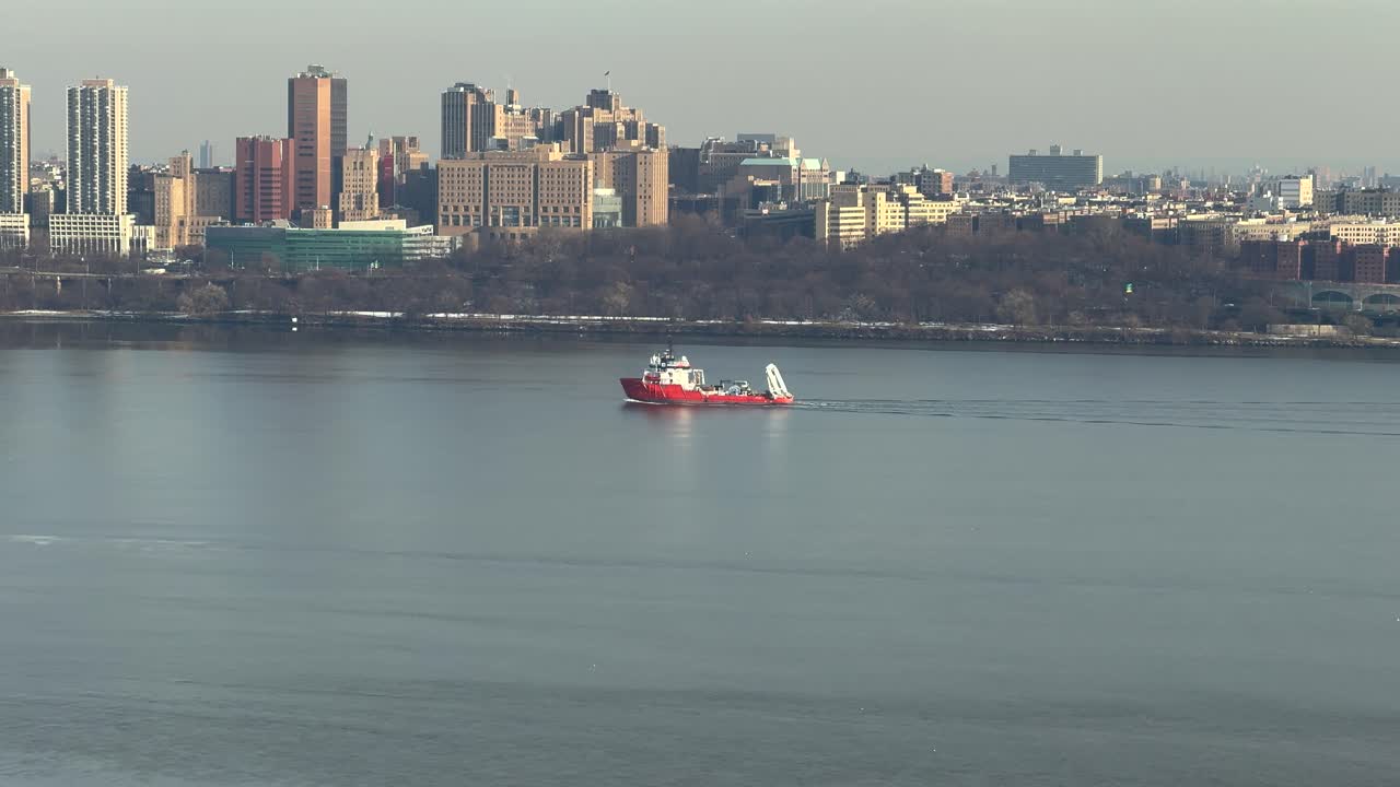 Boat sailing on the Hudson River with New York in the background.