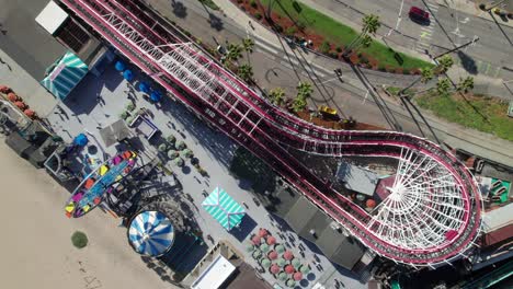 overhead of boardwalk amusement park with roller coaster, 4k