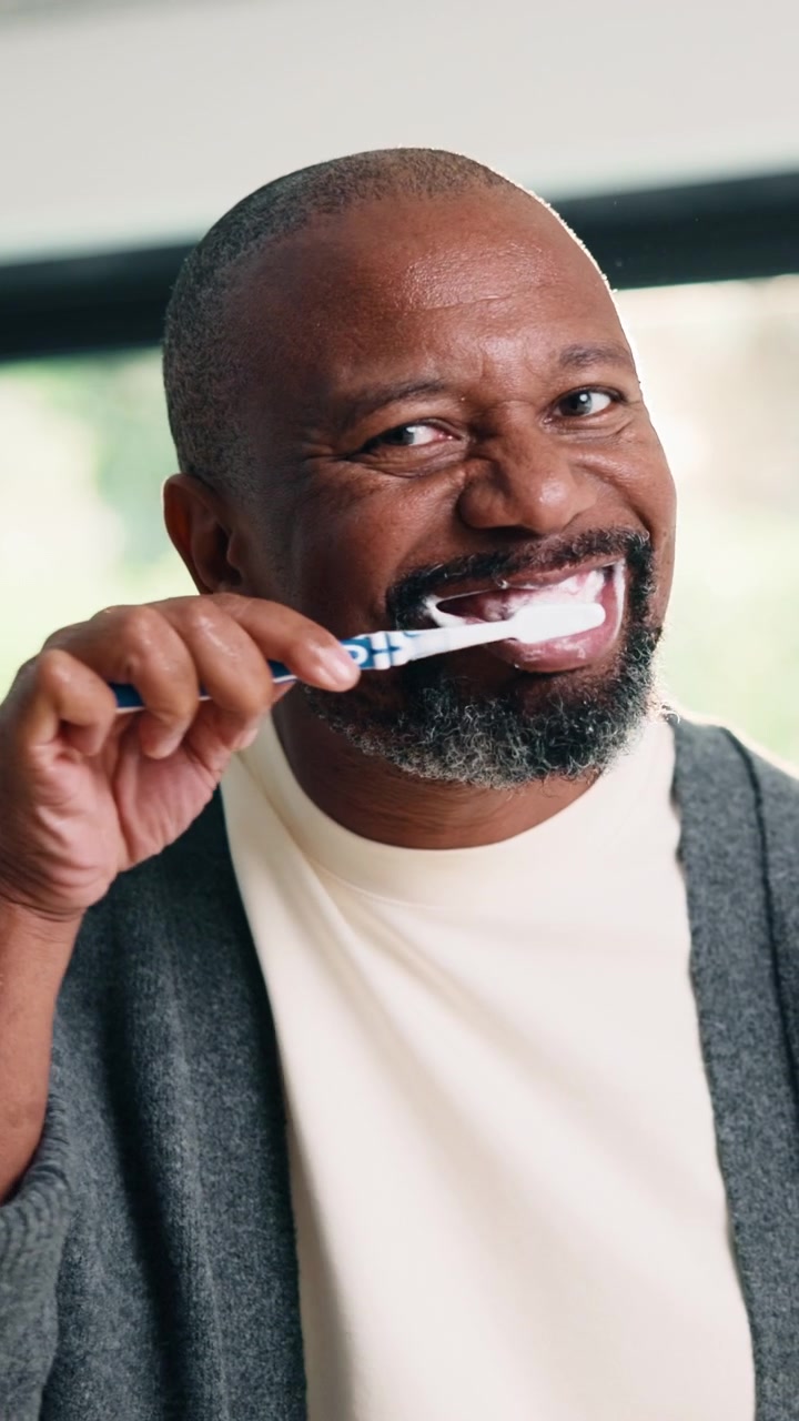 Mature Man Brushing Teeth in Morning Routine