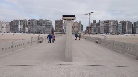 people walking on the pier of blankenberge, belgium. a concrete structure in art deco design
