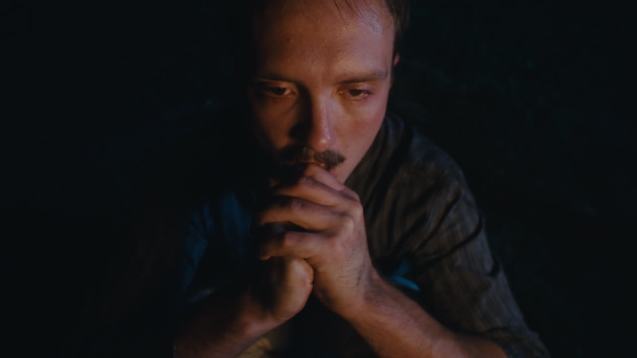 Pensive Man by Firelight in Darkness