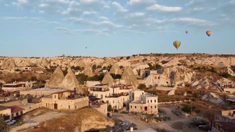 drone view of cappadoccia formations and balloons, goreme, turkey