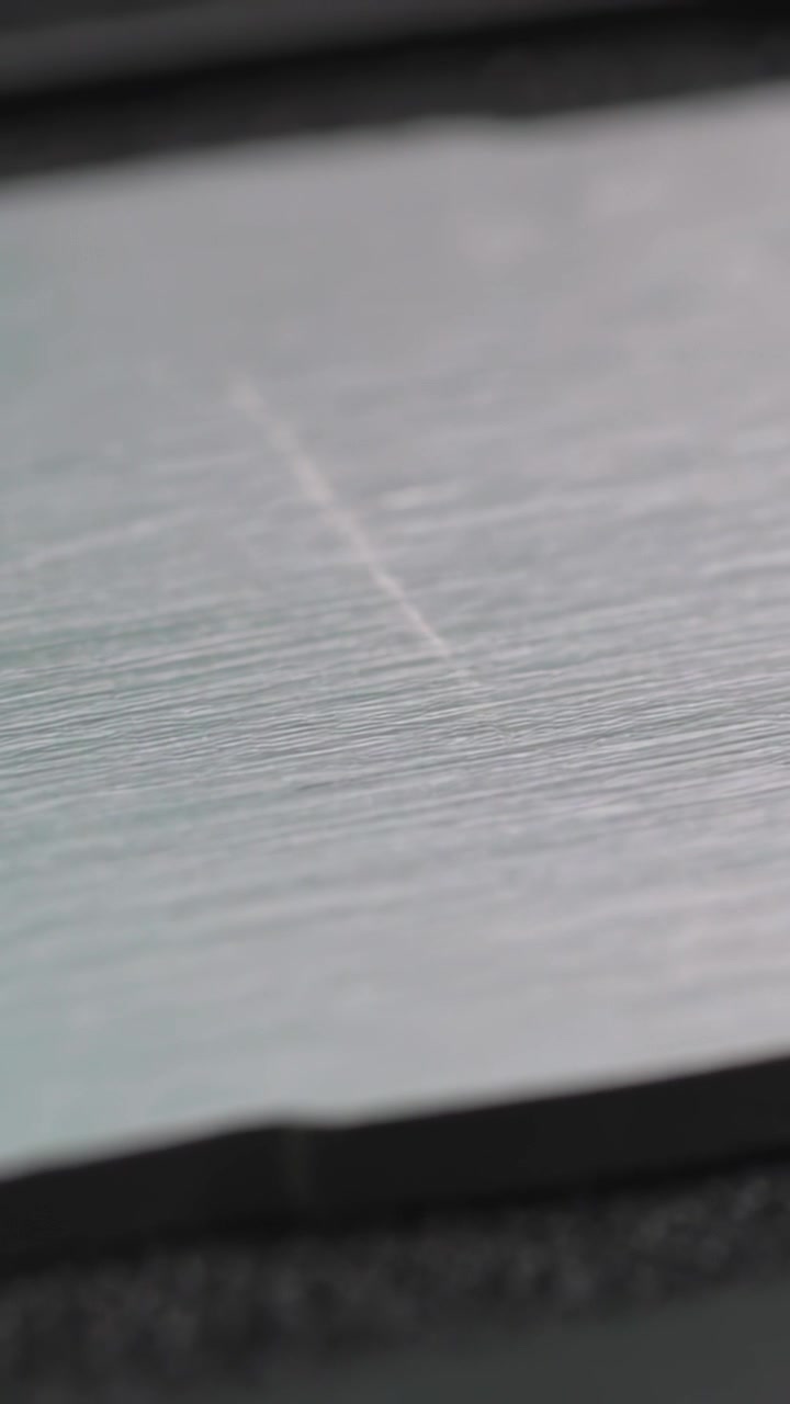 Vertical video: Zooming macro cam revealing brushed hex plate on bench checking scratch and chamfer