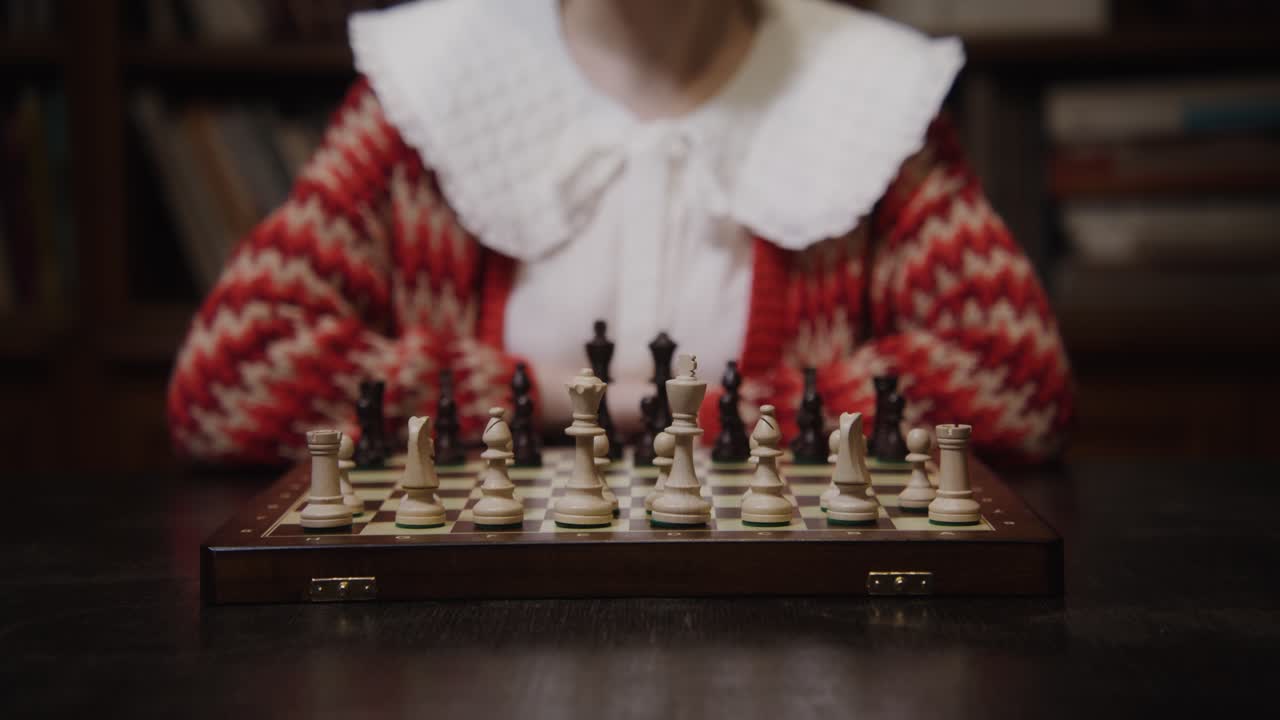 Child Playing Chess in a Library