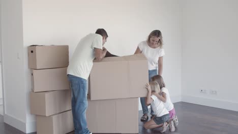 parents and two girls moving into new apartment