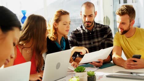 Team-of-executives-interacting-with-each-other-while-working-in-the-office