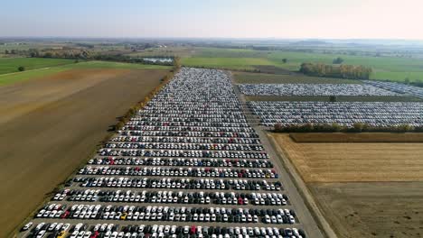 Aerial-footage-of-finished-cars-ready-to-be-shipped-on-huge-distribution-center