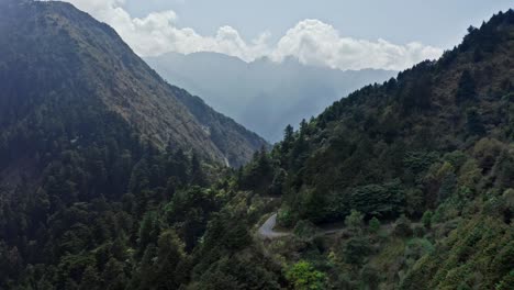 Epic-aerial-shot-of-Yushan-Yu-Shan-Mountain-in-Taiwan-during-sunny-day-with-clouds-in-background