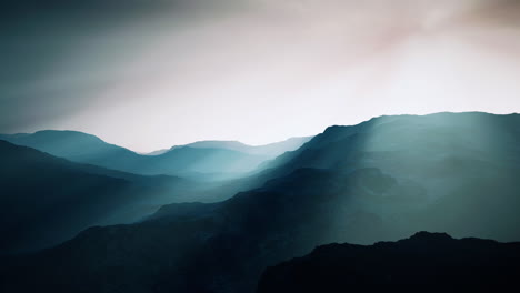 black-rocky-mountain-silhouette-in-deep-fog