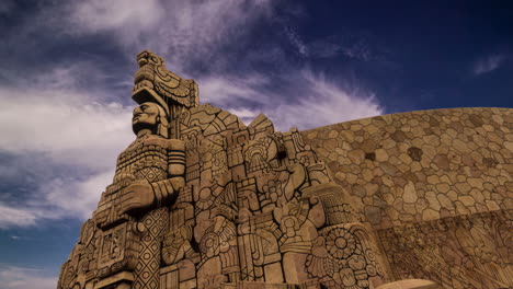 endless, continuous, looping cinemagraph of the monument to the homeland on the paseo de montejo in merida, yucatan, mexico with swirling clouds in blue sky