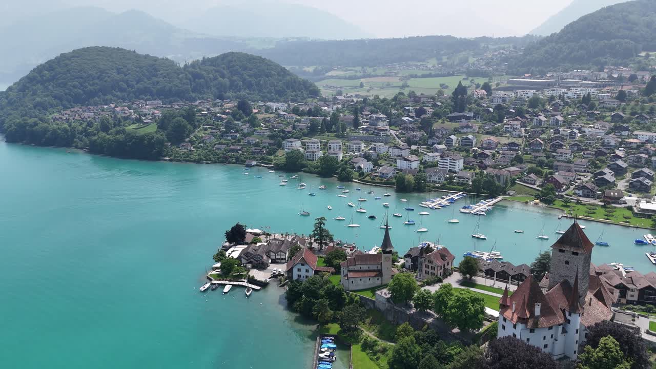 Spiez Town on lake Thun Switzerland pull back drone aerial reverse high angle