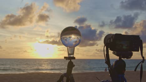 the camera is taking a picture of a glass ball.